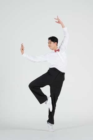 sale promotion concept, contemporary male dancer with smarphone on handの写真素材