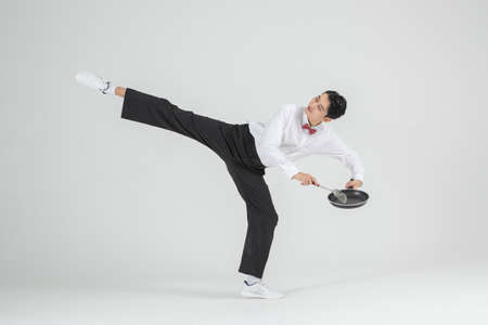 Asian male contemporary dancer holding cooking pan, food festival conceptの写真素材