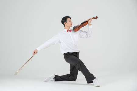 Asian female contemporary dancer with violinの写真素材