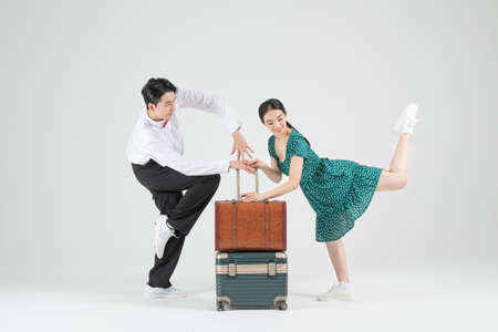 Asian couple contemporary dancers with travel bagの写真素材