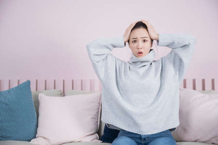 surprised Asian single solo woman living alone conceptの写真素材