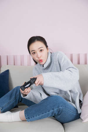 single solo woman living alone concept playing game with console