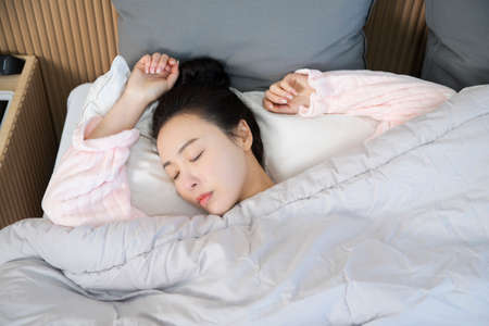 Asian woman sleeping in bed