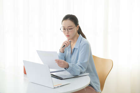 remote work, working at home concept of Asian woman in smart casual attire