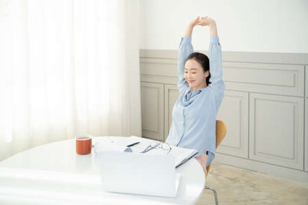remote work, working at home concept of Asian woman in smart casual attire