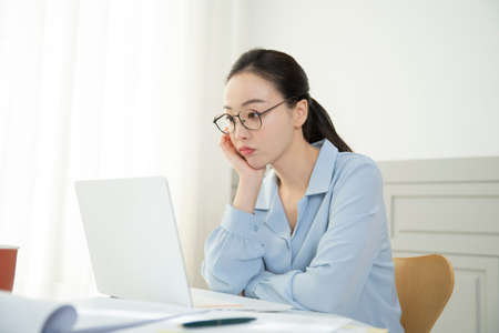 remote work, working at home concept of Asian woman in smart casual attire