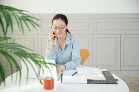 remote work, working at home concept of Asian woman in smart casual attire