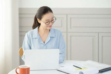 remote work, working at home concept of Asian woman in smart casual attire