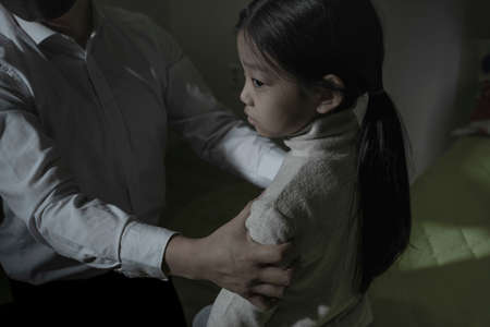 depressed Asian child in fear due to child abuse and violence, Human Rights Day concept