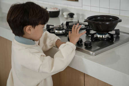 child abuse concept, Asian child with no food at home searching for food or trying to cookの写真素材