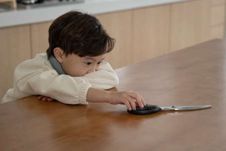 child abuse concept, Asian child with no food at home searching for food or trying to cookの写真素材