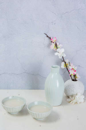 rice wine in porcelain bottle and cupsの写真素材