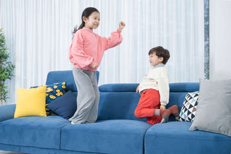 Asian boy and girl, family concept spending time at homeの写真素材