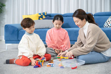 Asian mom and children, sister and brother family concept spending time at home