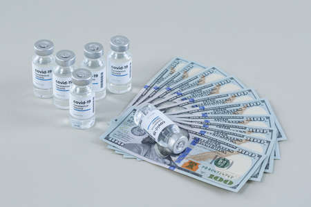 covid 19 vaccine and bill, paper moneyの写真素材