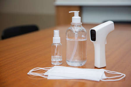 mask, hand sanitizer and thermometer