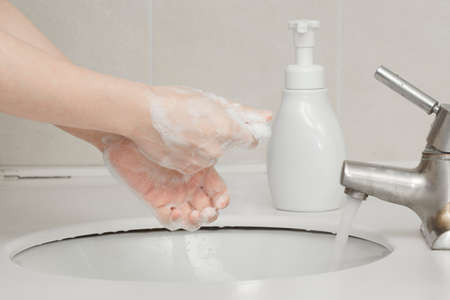 washing hands in sink