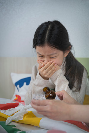 Asian girl drinking medicineの写真素材