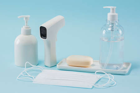 mask, hand sanitizer, thermometer and soapの写真素材