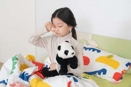 Asian girl awake in bed