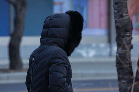 back shot of person on street in cold watherの写真素材