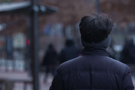 back shot of person on street in cold watherの写真素材