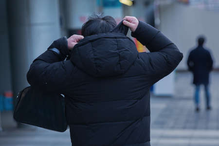 back shot of person on street in cold watherの写真素材