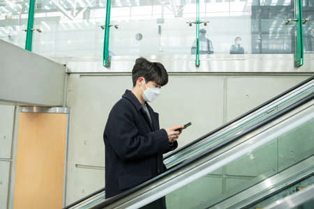 Asian man on escalator with face masks
