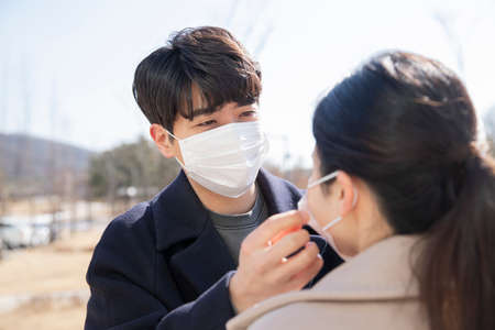 Asian couple with face masksの写真素材
