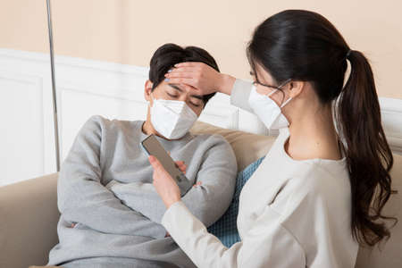 Asian couple wearing mask, worried due to  virusの写真素材