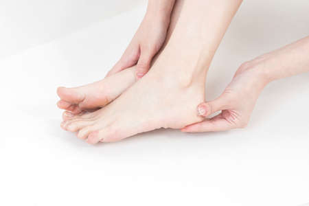 closeup of hands holding feetの写真素材