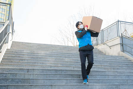 Asian delivery man working with maskの写真素材