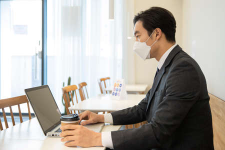 Asian businessman, customer with mask in cafe, business during covid  conceptの写真素材