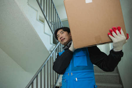 Asian delivery man, delivering boxes, goods to customers