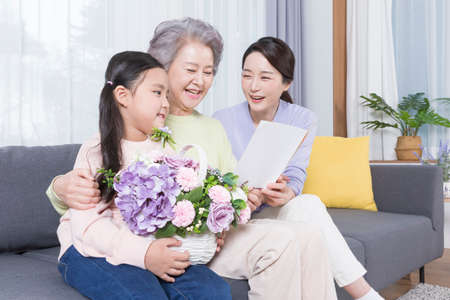 three generations of women, Asian grandmother, mother and grand daughter, birthday conceptの写真素材