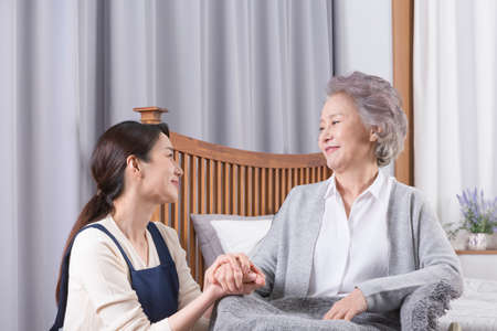 Asian caregiver and old woman at nursing home, hospitalの写真素材