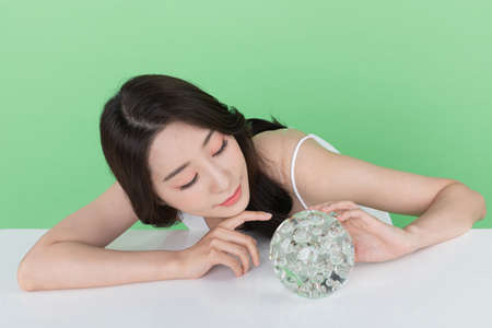 skin beauty concept, beautiful Korean Asian woman holding collagenの写真素材