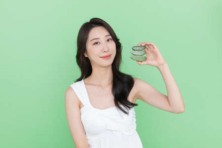 skin beauty concept, beautiful Korean Asian woman holding aloeの写真素材