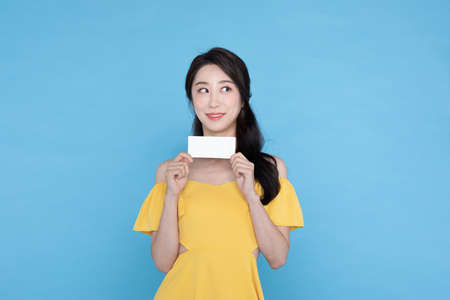 shopping event concept, beautiful Korean Asian woman with couponの写真素材