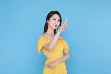 shopping event concept, beautiful Korean Asian woman with pointing fingerの写真素材