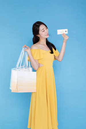 shopping event concept, beautiful Korean Asian woman with shopping bag and coupon