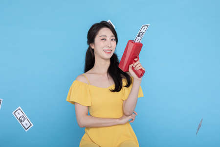 shopping event concept, beautiful Korean Asian woman with money coupon gun