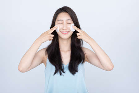 summer skin care, beautiful Asian woman with toner pads on faceの写真素材