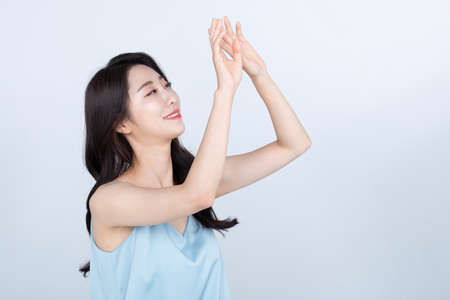beautiful Korean Asian young woman model covering herself from sun, summer skin beauty concept