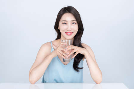 skin beauty, Asian woman supplements moisture on skin with waterの写真素材