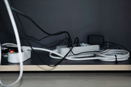 tangled plug lines and power stripの写真素材