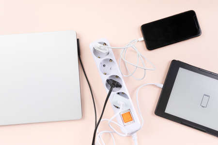 power strip and devices like laptop, smartphone being charged