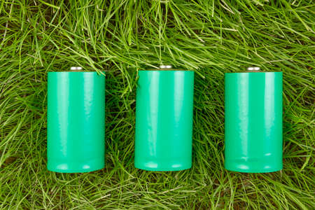eco friendly green batteries on grassの写真素材