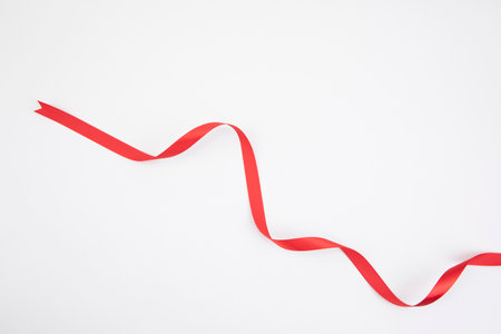 long red ribbon, white backgroundの写真素材