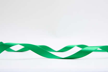 long green ribbon, white backgroundの写真素材